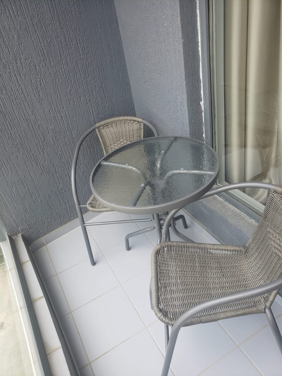 White Sails 6th floor apartment balcony bistro table two chairs outdoor seating
