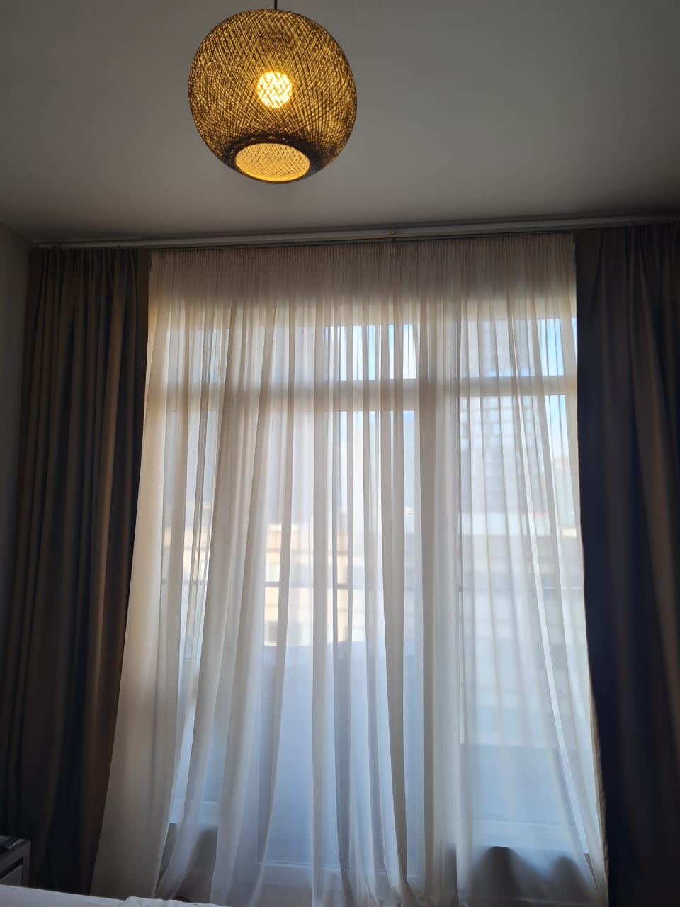 White Sails 6th floor apartment bedroom window rattan pendant light sheer curtains daylight